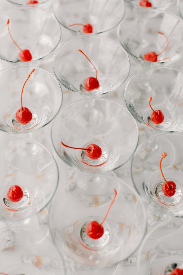 Top view of martini glasses with cherries, perfect for festive events and celebrations.